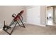 Inviting home gym with an inversion table and access to another room at 115 Avalini Way, North Venice, FL 34275