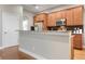 Kitchen with light wood cabinets and granite countertops at 115 Avalini Way, North Venice, FL 34275