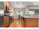 Modern kitchen with stainless steel appliances and granite countertops at 115 Avalini Way, North Venice, FL 34275