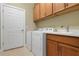 Laundry room with washer, dryer, and cabinets at 115 Avalini Way, North Venice, FL 34275