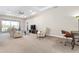 Living area with comfortable seating, a large TV and a workspace at 115 Avalini Way, North Venice, FL 34275