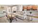 Bright living room with a beige recliner sofa and glass top coffee table at 115 Avalini Way, North Venice, FL 34275