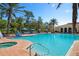 Large resort-style pool with multiple lounge chairs and umbrellas at 115 Avalini Way, North Venice, FL 34275