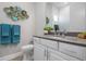 Modern bathroom with white vanity, gray countertop, and frameless shower at 12400 Davie Ct, Venice, FL 34293