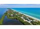 Aerial view of coastline with beach, ocean, and beachfront homes at 1313 Cypress Ave, Venice, FL 34285