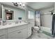 Clean bathroom with white vanity and bathtub at 1358 Leawood Rd, Englewood, FL 34223