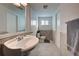 Clean bathroom with pedestal sink, toilet, and tiled floor at 1358 Leawood Rd, Englewood, FL 34223