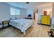 Bedroom with a queen-size bed and yellow dresser at 1358 Leawood Rd, Englewood, FL 34223