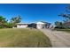 Ranch-style home with a large yard and screened porch at 1358 Leawood Rd, Englewood, FL 34223