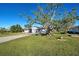 House with mature tree and a spacious lawn at 1358 Leawood Rd, Englewood, FL 34223
