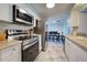 Modern kitchen featuring stainless steel appliances and ample cabinetry at 1358 Leawood Rd, Englewood, FL 34223