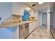Kitchen with stainless steel dishwasher and white cabinets at 1358 Leawood Rd, Englewood, FL 34223