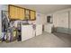 Convenient laundry room with washer, dryer, and storage cabinets at 1358 Leawood Rd, Englewood, FL 34223