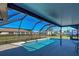 Relaxing screened-in pool with surrounding homes visible at 1358 Leawood Rd, Englewood, FL 34223