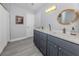 Modern bathroom with dual vanity and grey cabinets at 1363 Brookside Dr, Venice, FL 34285