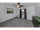 Bright bedroom with grey tile floors and ceiling fan at 1363 Brookside Dr, Venice, FL 34285