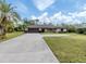 Single-story home with attached garage and spacious driveway at 1363 Brookside Dr, Venice, FL 34285