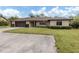 Single-story home with a two-car garage and manicured lawn at 1363 Brookside Dr, Venice, FL 34285