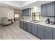 Modern kitchen with gray cabinets, stainless steel appliances, and quartz countertops at 1363 Brookside Dr, Venice, FL 34285