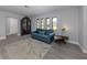 Living room with gray floors, teal couch, and a mid-century modern feel at 1363 Brookside Dr, Venice, FL 34285