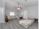 Relaxing living room featuring a sectional sofa and wood-look floors at 1363 Brookside Dr, Venice, FL 34285