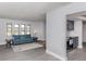 Bright living room featuring a blue sofa and gray wood-look floors at 1363 Brookside Dr, Venice, FL 34285