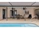 Spacious pool area with patio furniture and fans at 1363 Brookside Dr, Venice, FL 34285