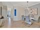 Bright dining room with a modern table and gray chairs, offering ample space at 17108 Vardon Ter # 308, Bradenton, FL 34211