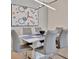 Modern dining room with white table and gray chairs, perfect for entertaining at 17108 Vardon Ter # 308, Bradenton, FL 34211