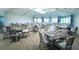 Elegant dining room with numerous tables and chairs at 17108 Vardon Ter # 308, Bradenton, FL 34211