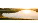 Scenic lake view at sunrise with lush greenery and calm waters at 17108 Vardon Ter # 308, Bradenton, FL 34211
