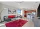 Spacious living room with gray leather sofa and red rug, offering a relaxing atmosphere at 17108 Vardon Ter # 308, Bradenton, FL 34211