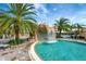 Resort-style pool with a waterfall feature and palm trees at 17108 Vardon Ter # 308, Bradenton, FL 34211