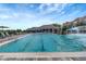 Lapped pool with waterfall and surrounding lounge area at 17108 Vardon Ter # 308, Bradenton, FL 34211