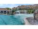 Inviting pool with a large rock waterfall feature at 17108 Vardon Ter # 308, Bradenton, FL 34211