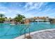Large pool with a rock waterfall and lounge chairs at 17108 Vardon Ter # 308, Bradenton, FL 34211