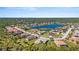 Wide aerial view of the neighborhood, highlighting its location near a lake at 19718 Cobblestone Cir, Venice, FL 34292