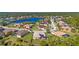 Community overview featuring a tranquil lake and numerous homes at 19718 Cobblestone Cir, Venice, FL 34292