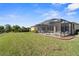 Large backyard featuring a screened pool and patio area at 19718 Cobblestone Cir, Venice, FL 34292