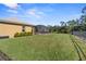 Spacious backyard with a screened enclosure and lush green grass at 19718 Cobblestone Cir, Venice, FL 34292