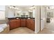 Double vanity bathroom with granite countertops, large mirror, and a soaking tub at 19718 Cobblestone Cir, Venice, FL 34292