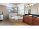 Spa-like bathroom with a large walk-in shower, corner soaking tub, and granite vanity at 19718 Cobblestone Cir, Venice, FL 34292