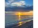 Stunning sunset over the ocean, with people enjoying the beach at 19718 Cobblestone Cir, Venice, FL 34292