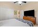 Bedroom with large TV, dresser, and double door closet at 19718 Cobblestone Cir, Venice, FL 34292