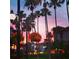Scenic sunset view of palm trees and shops at 19718 Cobblestone Cir, Venice, FL 34292