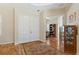 Elegant entryway with hardwood floors and views into a home office at 19718 Cobblestone Cir, Venice, FL 34292