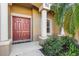 Welcoming entryway with double doors and landscaping at 19718 Cobblestone Cir, Venice, FL 34292
