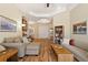 Bright living room with hardwood floors, comfortable seating, and views to entryway and kitchen at 19718 Cobblestone Cir, Venice, FL 34292