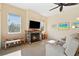 Spacious living room with stone fireplace and large windows at 19718 Cobblestone Cir, Venice, FL 34292