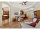 Open living room with hardwood floors, kitchen view, and access to formal dining area at 19718 Cobblestone Cir, Venice, FL 34292